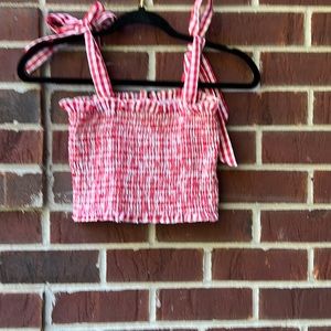 Smock tube top with tie shoulder straps.